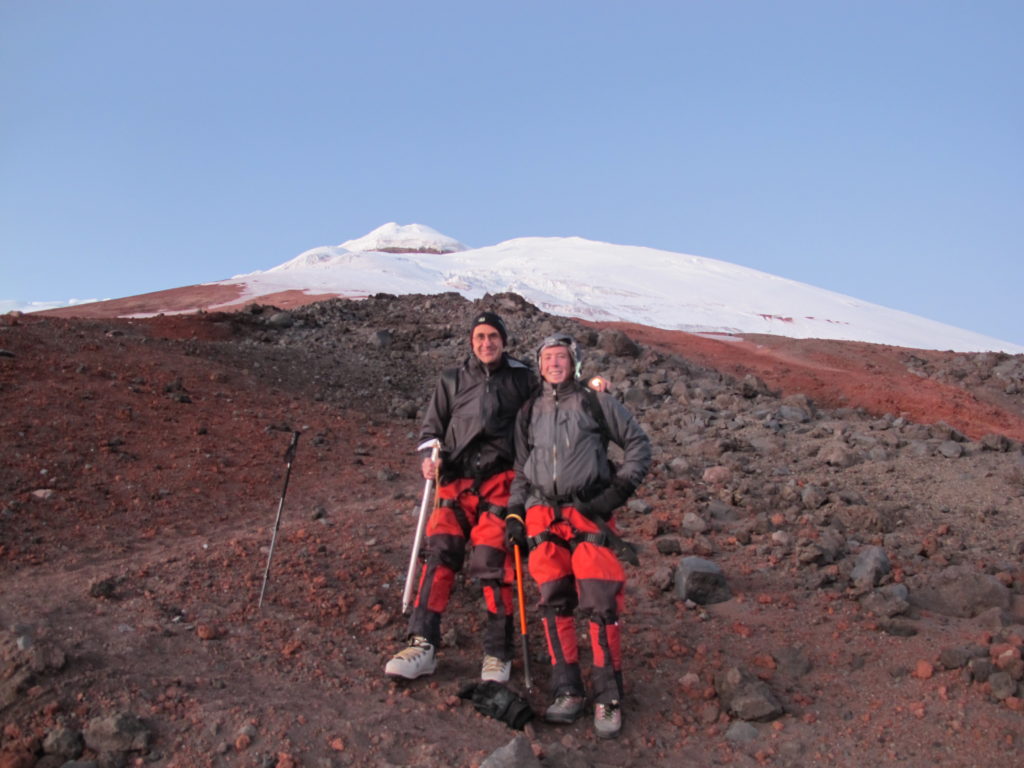 Father and son roped together while ascending the snow-covered slopes of Cotopaxi Volcano in Ecuador