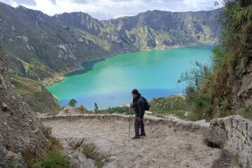 Hikers overlooking the stunning Quilotoa Crater Lake during a trekking tour in the Ecuadorian Andes
