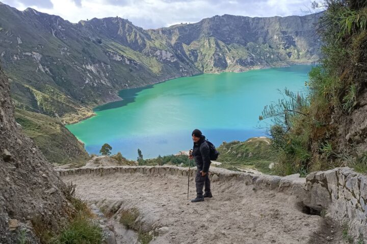 Hikers overlooking the stunning Quilotoa Crater Lake during a trekking tour in the Ecuadorian Andes