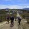 Hikers walking along a rural road on the Quilotoa Loop in the Ecuadorian Andes.
