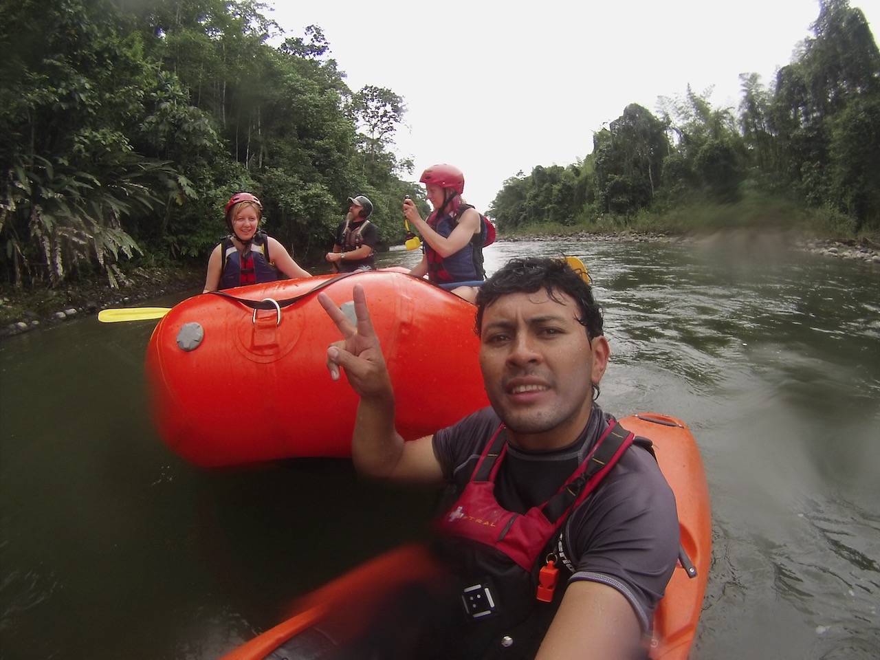 Diego guiding travelers on a river in Ecuador, showing the human side of Ecuadorian travel and culture