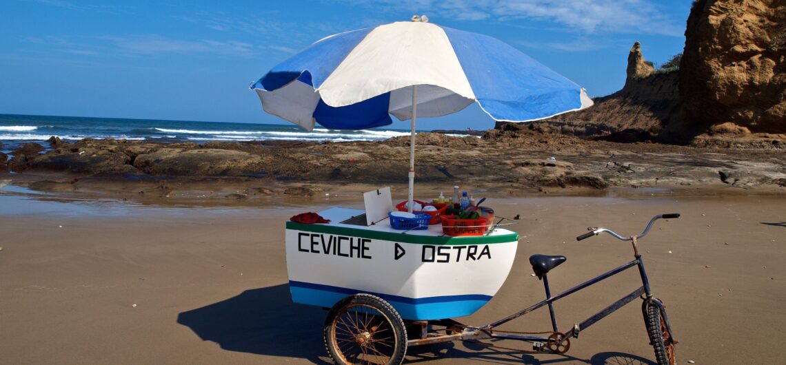 Small beach cart serving fresh ceviches and oysters on the coast of Ecuador, showcasing local seafood traditions.