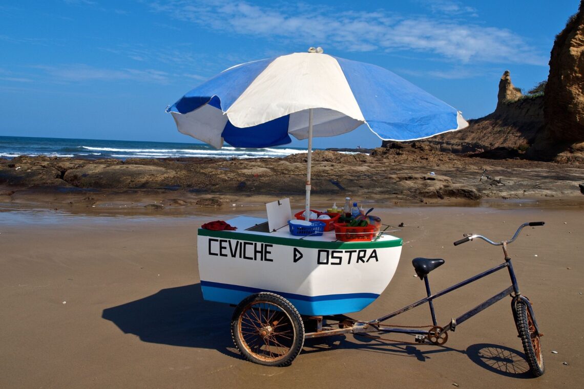 Small beach cart serving fresh ceviches and oysters on the coast of Ecuador, showcasing local seafood traditions.