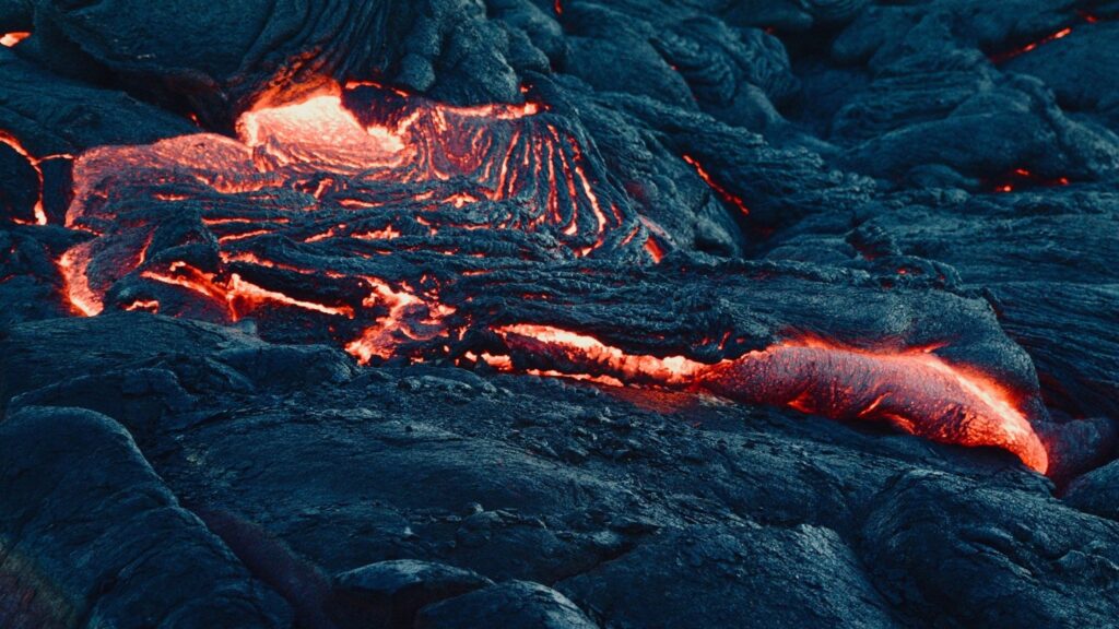 Red-hot lava cools into black basalt rock on Fernandina Island, Galápagos — a living reminder of the islands' volcanic origins. This raw moment captures nature in transformation, as the Earth's molten core meets the oceanic crust.