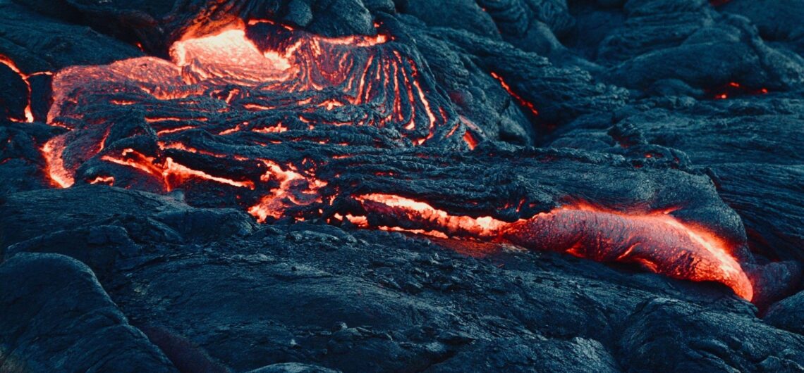 Red-hot lava cools into black basalt rock on Fernandina Island, Galápagos — a living reminder of the islands' volcanic origins. This raw moment captures nature in transformation, as the Earth's molten core meets the oceanic crust.