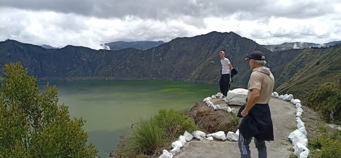 Traveler overlooking Quilotoa crater lake in the Ecuadorian Andes