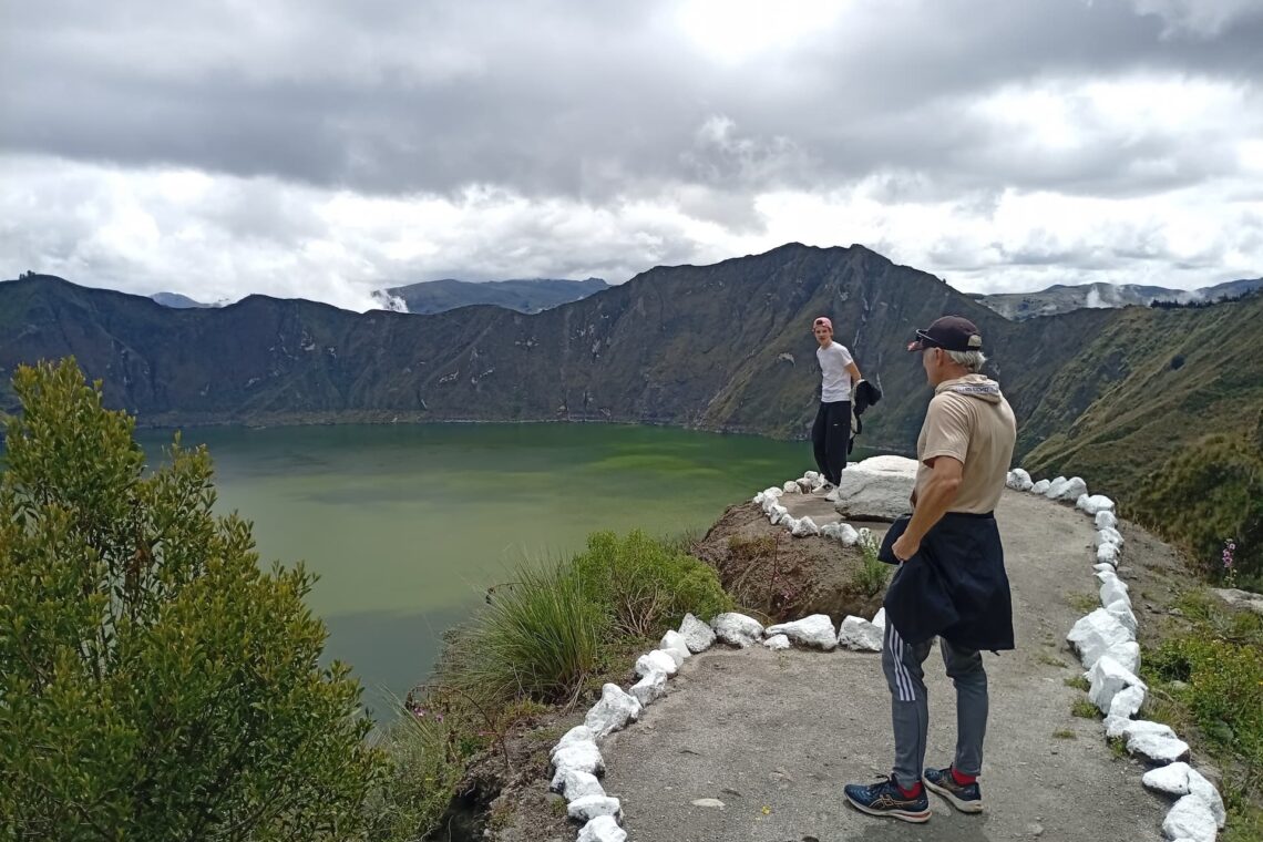 Traveler overlooking Quilotoa crater lake in the Ecuadorian Andes