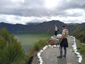 Traveler overlooking Quilotoa crater lake in the Ecuadorian Andes